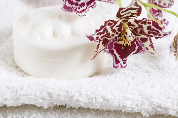 Image showing Spa items with white towels, natural soap and orchid