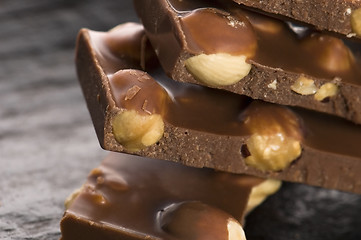 Image showing Pile of broken chocolate with nuts