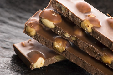 Image showing Pile of broken chocolate with nuts