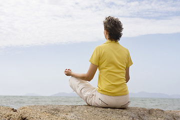 Image showing Woman meditating at the sea