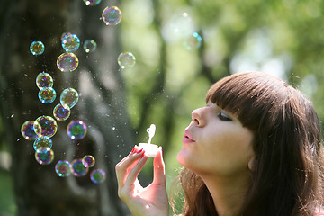 Image showing girl blows soap bubbles