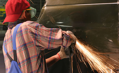 Image showing worker cuts metal