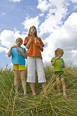 Image showing Childrem blowing bubbles