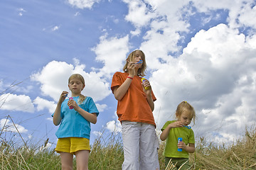 Image showing Childrem blowing bubbles