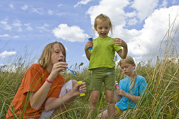 Image showing Childrem blowing bubbles