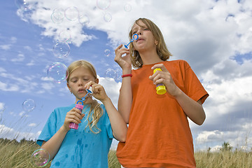 Image showing Childrem blowing bubbles