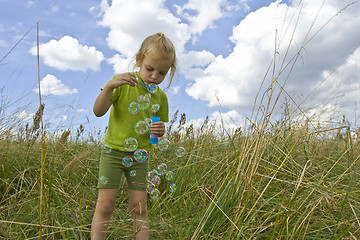 Image showing Childrem blowing bubbles