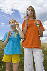 Image showing Childrem blowing bubbles