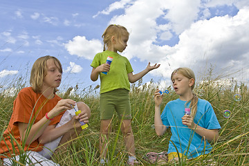 Image showing Childrem blowing bubbles