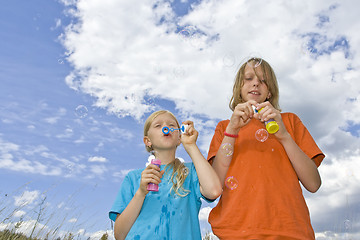 Image showing Childrem blowing bubbles