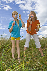 Image showing Childrem blowing bubbles