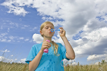 Image showing Childrem blowing bubbles