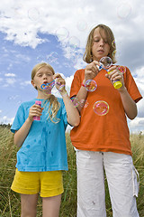 Image showing Childrem blowing bubbles