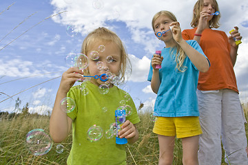 Image showing Childrem blowing bubbles