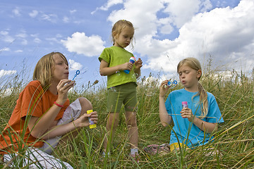 Image showing Childrem blowing bubbles