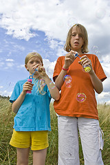 Image showing Childrem blowing bubbles