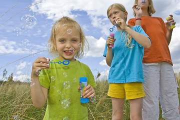 Image showing Childrem blowing bubbles