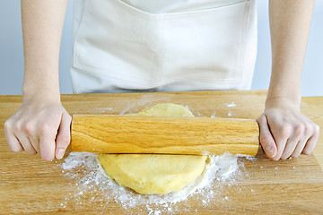 Image showing Hands with rolling pin and cookie dough