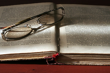 Image showing aging book and spectacles for correcting the vision