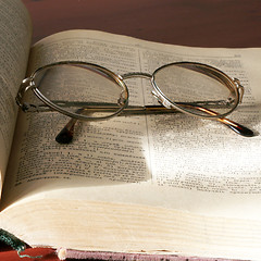 Image showing aging book and spectacles for correcting the vision