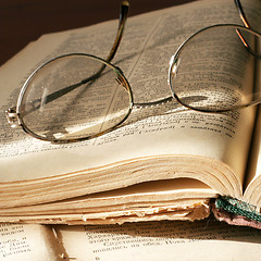 Image showing aging book and spectacles for correcting the vision