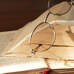 Image showing aging book and spectacles for correcting the vision