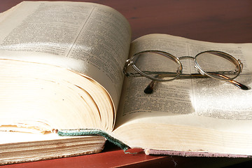 Image showing aging book and spectacles for correcting the vision