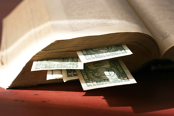 Image showing old paper bills and aging book