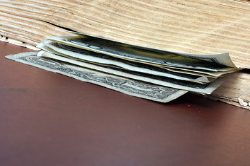 Image showing old paper bills and aging book