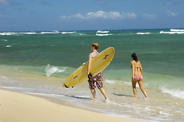 Image showing Young couple walking on a hawaiian beach