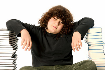 Image showing boy unhappy and many books