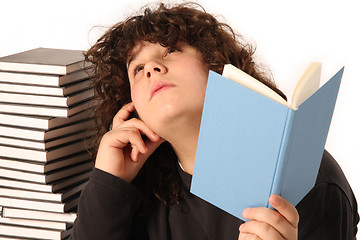 Image showing boy thinking and reading a book 