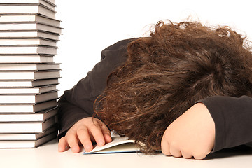 Image showing boy sleeping and and many books 