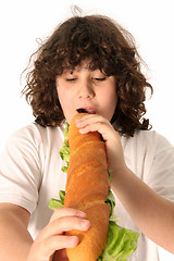 Image showing boy eating large sandwich 