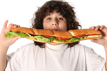 Image showing boy eating large sandwich 