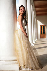 Image showing smiling princess in white-golden gown in gallery