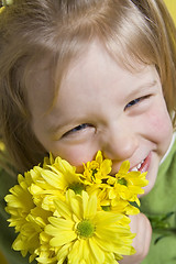 Image showing Girl and yellow flowers