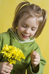 Image showing Girl and yellow flowers