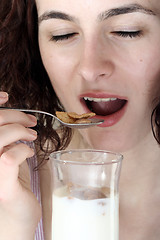 Image showing Young people eating milk with cereals