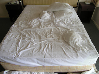 Image showing Used motel room bed.