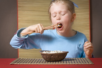 Image showing Eating rice