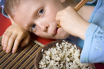 Image showing Eating rice