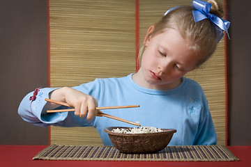 Image showing Eating rice