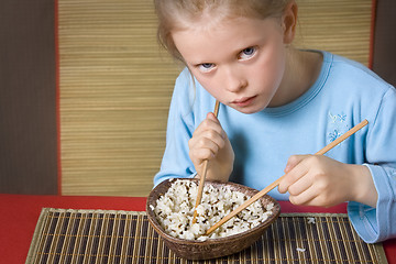 Image showing Eating rice