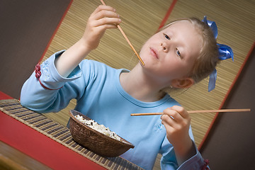 Image showing Eating rice