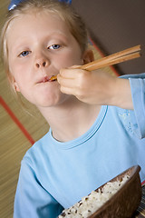 Image showing Eating rice