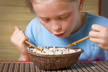 Image showing Eating rice