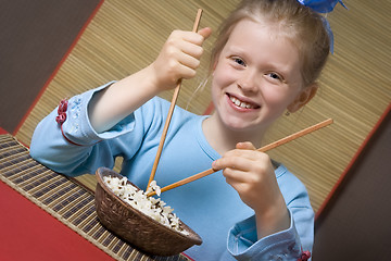 Image showing Eating rice