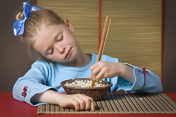 Image showing Eating rice