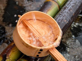 Image showing Bamboo ladle and splash